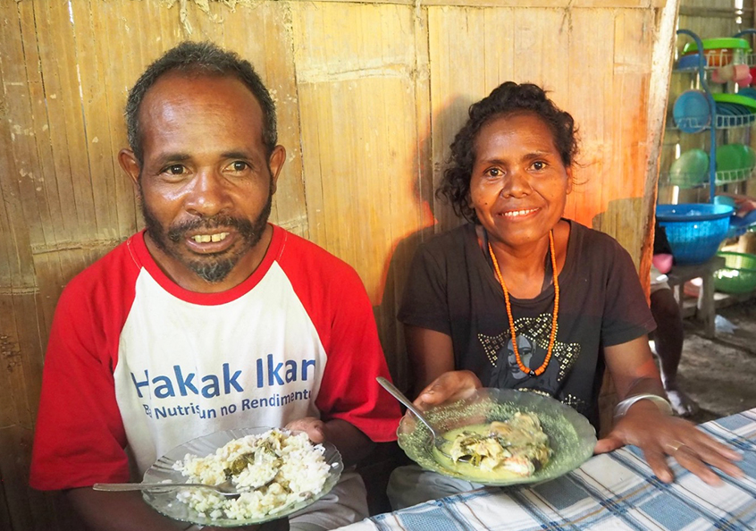 Farmers eating fish in Timor-Leste