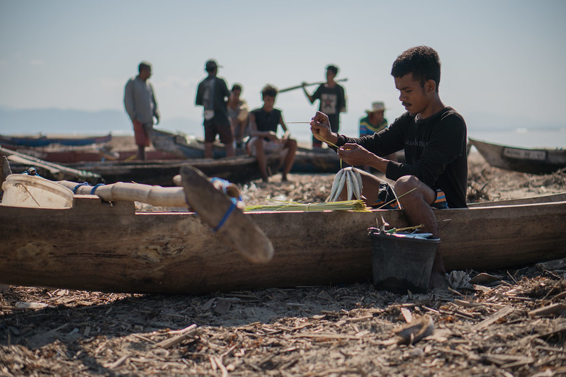 A young fisher returns from sea with his catch and prepares it for sale in Viqueque district, Timor-Leste.