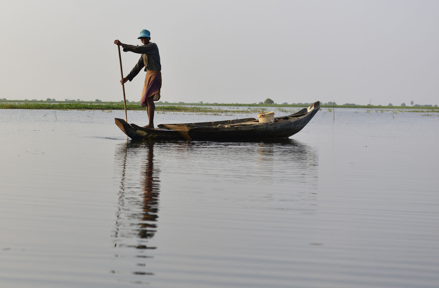 Fisherman on Rohal Suong conservation pond, Battambang province, Cambodia. Photo by Sylyvann Borei.