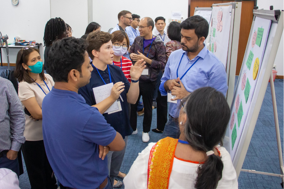 Researchers discussing country and partner strategic actions for nutrition-sensitive food systems work during the AMD Initiative workshop. Photo by Sam