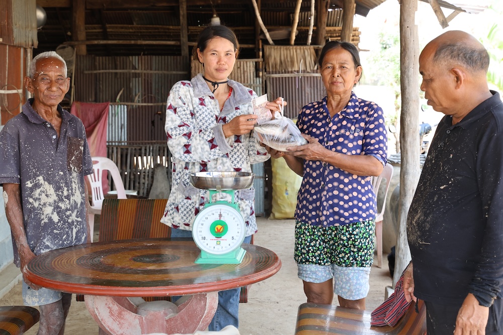 Selling fish from ricefield pond to neighbor, Takeo province