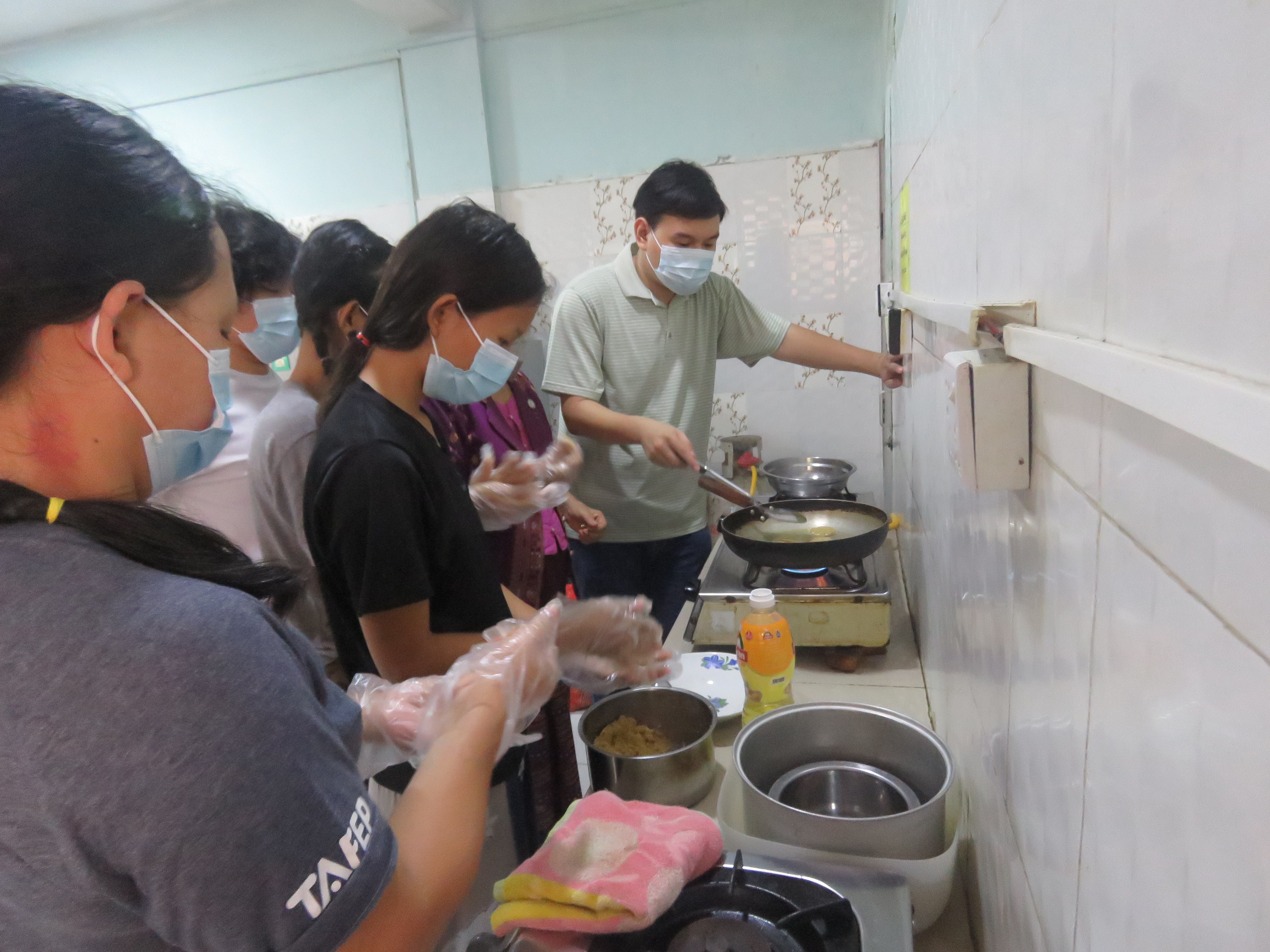 Youths learn to cook with FedWell’s dried small fish powder. Photo by Nge Nge Lwin.
