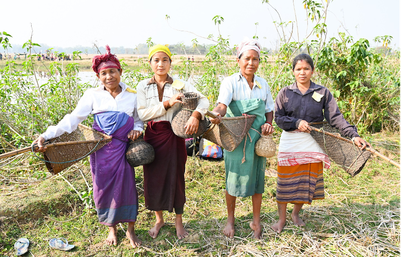 Rabha women with their traditional fishing gear ready to participate in Bahow, their community fishing practice. Photo: SK Dubey 