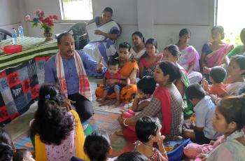 Participants learn about the nutritional benefits of small fish and how simple household practices can improve family diets during a community event in Assam.
