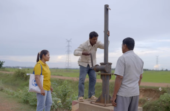 Chea Kong (left) coordinates with local authorities to open the watergate in Santuk District, Kampong Thom, managing water flows that sustain both rice fields and community fish refuges. Photo: WorldFish.