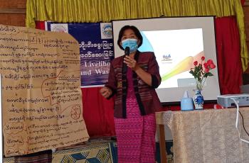 Daw Khin Soe Win, the Group Leader of Early Childhood Care and Development, speaks on the nutritional benefits of small fish.  