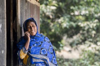 A  private sector facilitator (PSF) talking on phone. Photo by Foto Agencies.