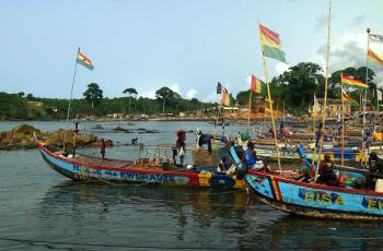 Large fishing canoes prepare their 'watsa' purse seine nets to go to sea in search of sardinella catches in Dixcove, western Ghana. Photo by David Mills.