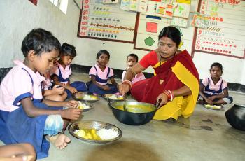 Bangabandha Anganwadi center children enjoying small fish in Hot cooked meals of Supplementary Nutrition programme of ICDS, under the pilot feeding programme Odisha. Photo by Baishnaba Charan Ratha.