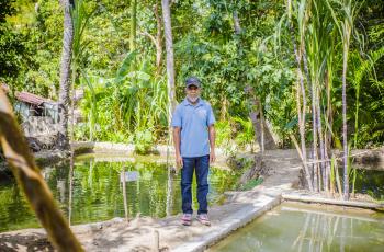 Domingos da Silva Brites is a fish farmer in Parlamento, Lautem municipality. He proudly stands by his ponds, as fish farming has provided him with vital income. Photo by Shandy Santos.