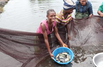 Showing off fish. Photo by Agness Chileya.