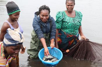 Mary Lundeba shows off fish from the women's pond. Photo by Agness Chileya, WorldFish.