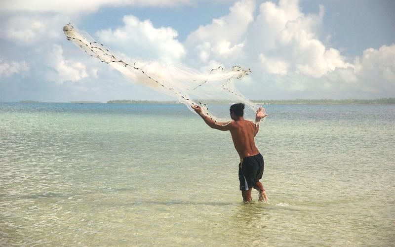 A fisherman casts his net in the Republic of Kiribati. Photo by Quentin Hanich