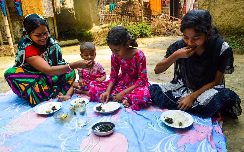 Pronoti Rani and her children eat nutrient-rich small fish in their meal in Moulavibazar, Bangladesh. Photo by Mohammad Mahabubur Rahman.