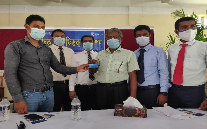 A farmer from Gaibandha receives a Fish Card as part of obtaining a loan from Bank Asia. Photo by Debasish Bhattacharjee/WorldFish