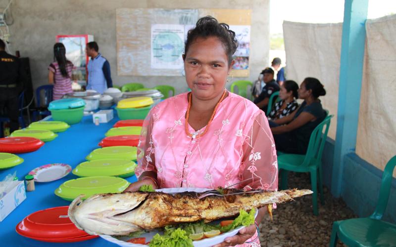 Timorese woman with a traditional fish