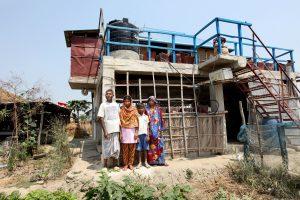 Maherunessa with her family in front of her climate-smart house in Satkhira, Bangladesh. Photo by M. Yousuf Tushar, 2014.