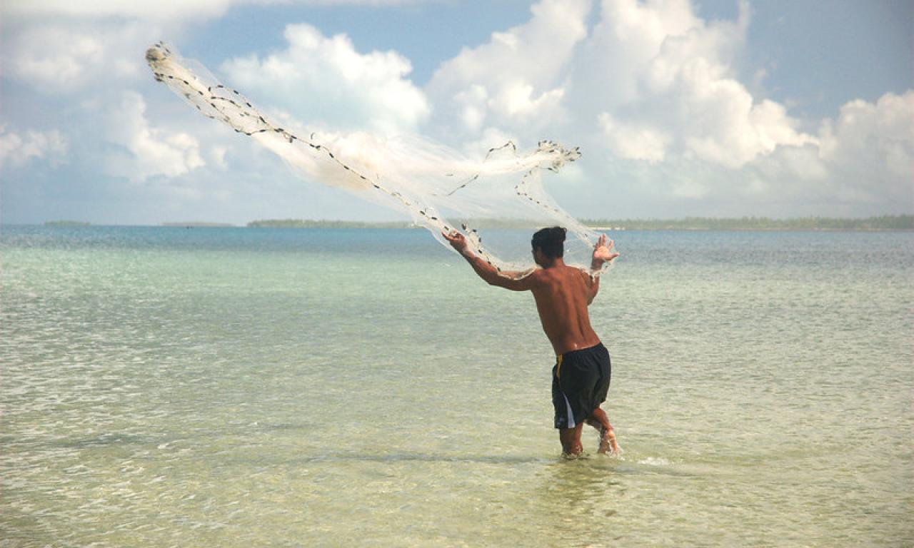 A fisherman casts his net in the Republic of Kiribati. Photo by Quentin Hanich