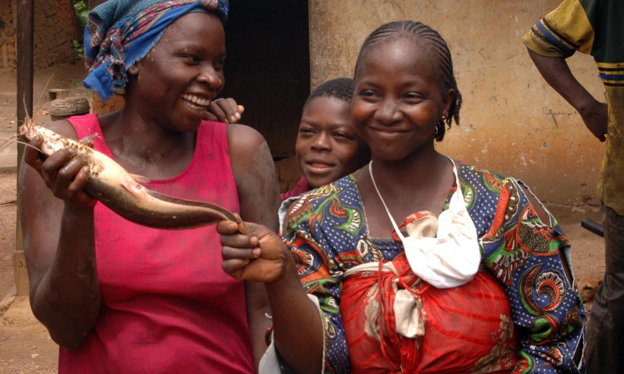 Fisherwomen hold a catfish harvested from their pond in Cameroon. Photo by Randall Brummett. 