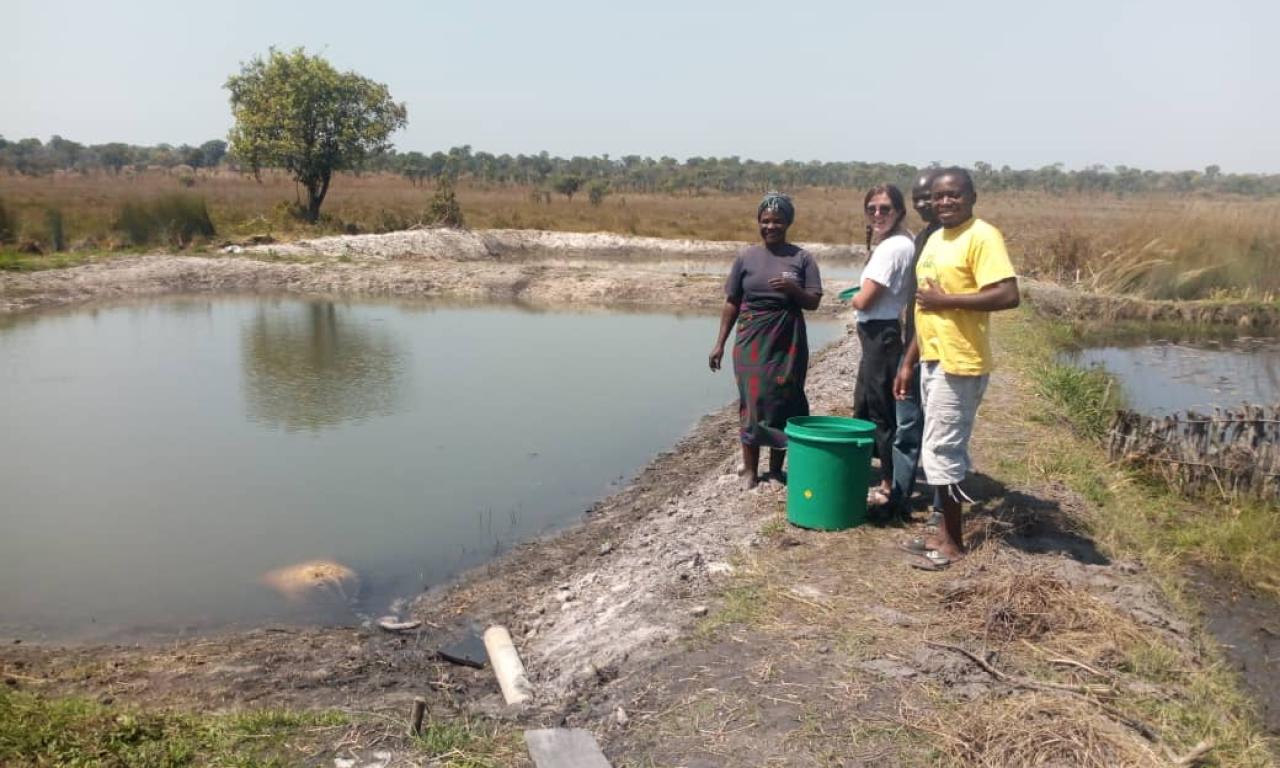 Lulu and Muleya training providing training to women by her pond in Luwingu, Northern Province, Zambia. Photo by Kendra Byrd.