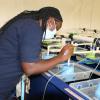 WorldFish scientist conducting a physical inspection of eggs in the hatchery at NARDC in Kitwe, Zambia