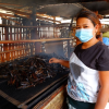 Win Chewa Htun produces smoked fish for a living together with her husband. Photo by Kyaw Moe Oo.